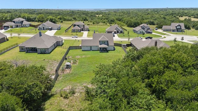 Aerial view of residential area featuring a forest | Image 24