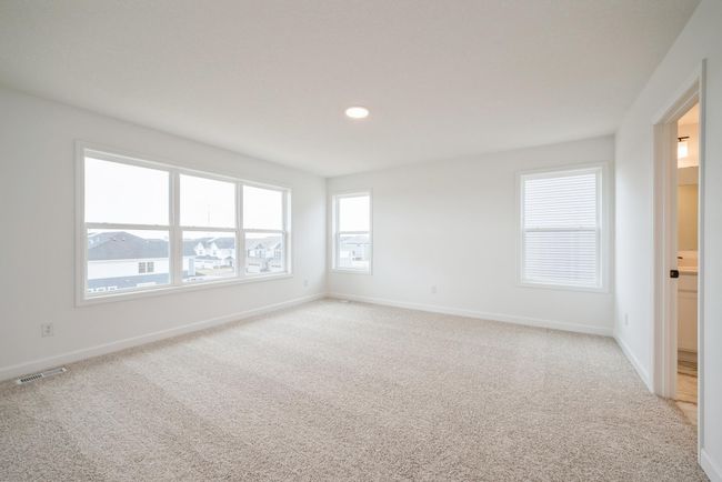 Photo is of the actual home. Find your retreat in the stunning primary bedroom. Enjoy the exclusivity of a private bath and huge walk-in closet. | Image 9