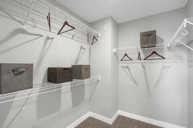 The large primary suite is an oasis and offers a private bath and two walk in closets. Model photos. Options and colors will vary. | Image 24