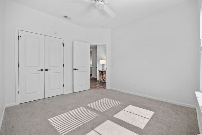 Unfurnished bedroom with baseboards, carpet, a closet, and visible vents | Image 19