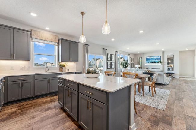 Open plan living, a window over the sink, and an abundance of storage. Photo of model home, colors and finishes will vary. | Image 6