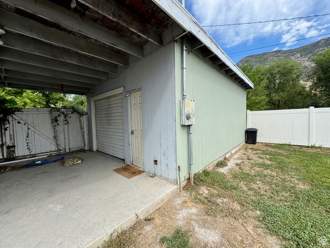 View of side of home with a mountain view, fence, and a gate | Image 20