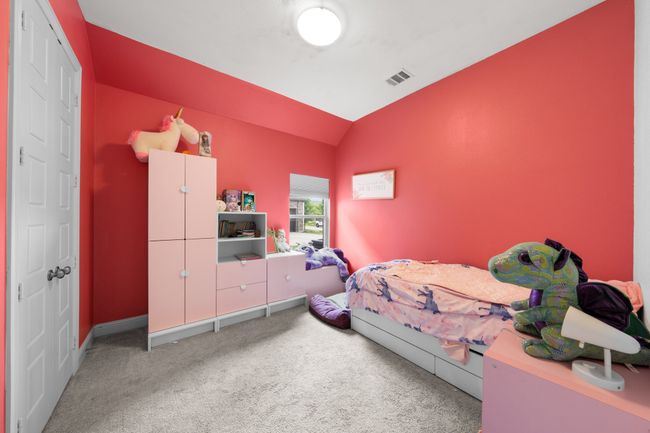 Carpeted bedroom with vaulted ceiling and baseboards | Image 19