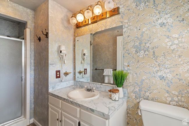 Full bathroom featuring vanity, a stall shower, and toilet | Image 19