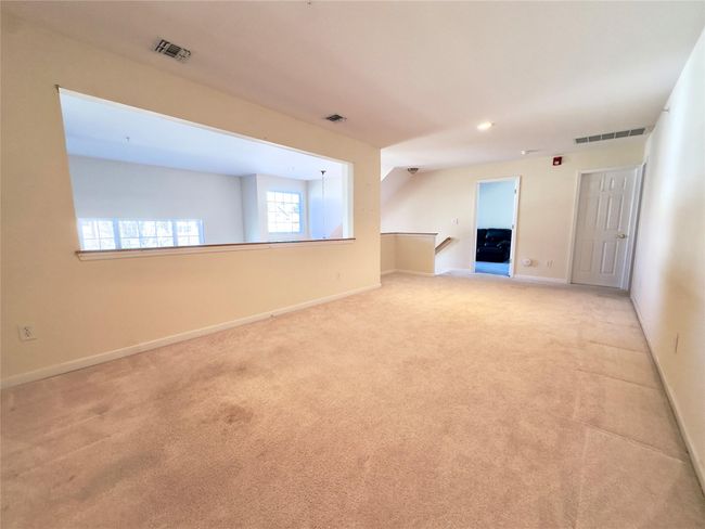 Carpeted Loft room featuring baseboards and visible vents | Image 12