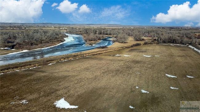 Drone shot from above. Property line runs with ditch and ends at the treeline. This would potentially be a great building spot of breathtaking views of the Clarks Fork of the Yellowstone. This location is only 10 minutes to Laurel, Montana, 25 minutes to Billings and an hour from Cody, Wyoming and the gates of Yellowstone Park. | Image 17
