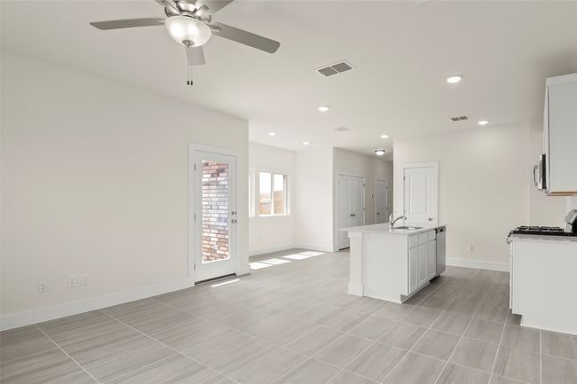 Kitchen with a sink, baseboards, ceiling fan, and visible vents | Image 8