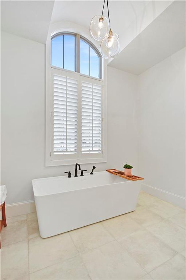 Full bath featuring tile patterned flooring, baseboards, and a freestanding tub | Image 36