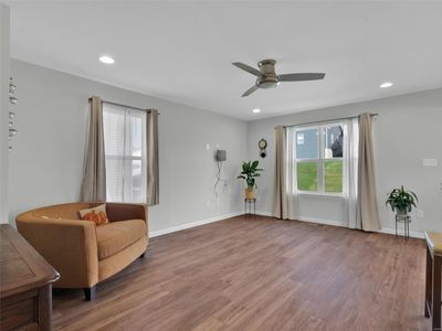 Comfortable Living area features Luxury Plank floors, canned lighting and ceiling fan | Image 3