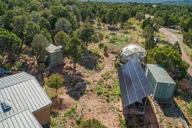 Fully owned 8.5kW solar array, greenhouse, and two storage containers, with orchard in background | Image 50