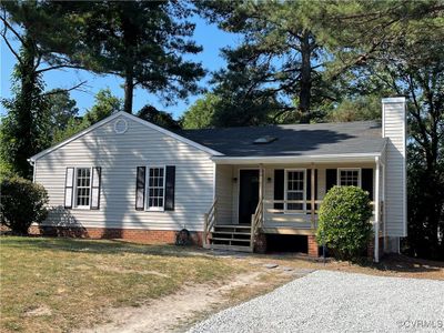 Single story home featuring covered porch and a front yard | Image 1