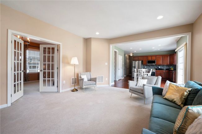 The family room offers French doors that lead to the formal living room. | Image 8