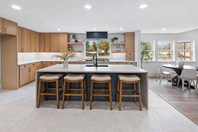 Kitchen with open shelves, recessed lighting, light countertops, a kitchen island with sink, and tasteful backsplash | Image 15