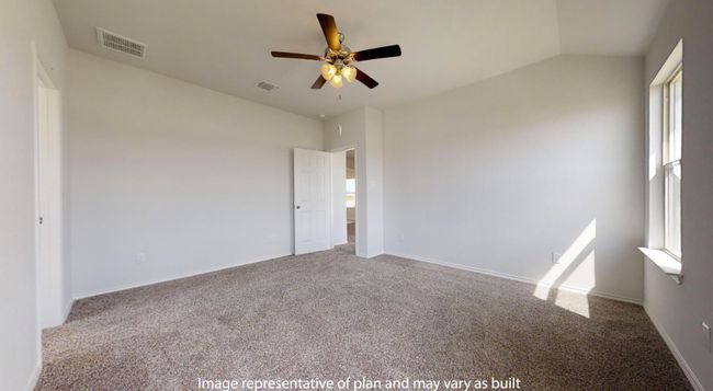 Carpeted empty room featuring a ceiling fan, plenty of natural light, lofted ceiling, and baseboards | Image 14