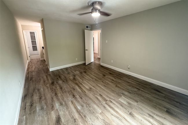 Unfurnished room featuring ceiling fan and wood finished floors | Image 23