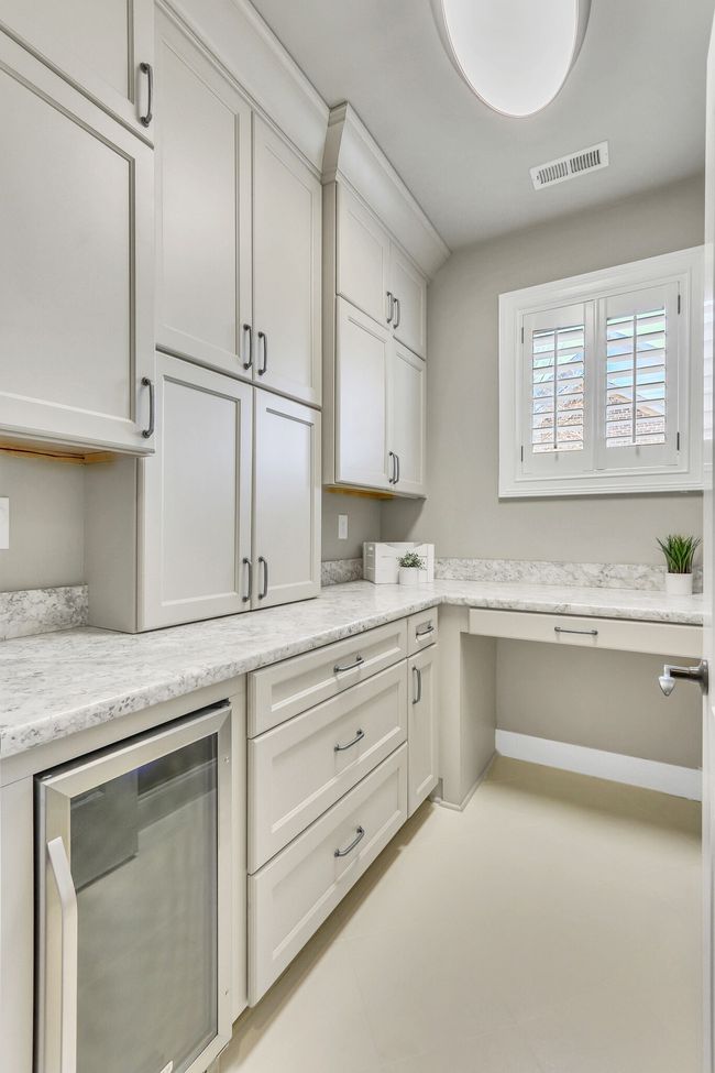 This upstairs hobby room has a beverage refrigerator for the bonus room and built-in shelves and drawers for storage. Or use this for your favorite past time or side gig. What would you do with this gift of storage? | Image 44