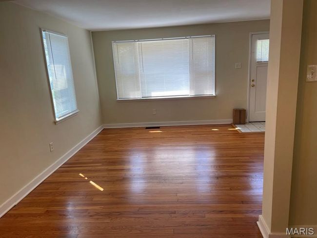 Spare room with baseboards, wood finished floors, and visible vents | Image 6