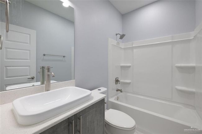 Full bath with toilet, bathtub / shower combination, and vanity | Image 13