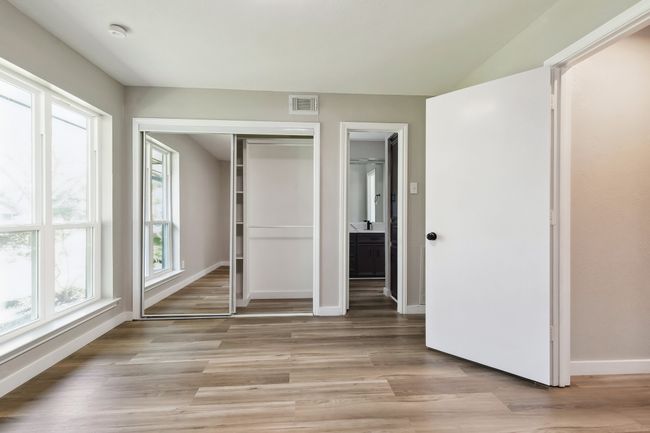 Unfurnished bedroom featuring light wood-style flooring, a sink, visible vents, a closet, and baseboards | Image 22