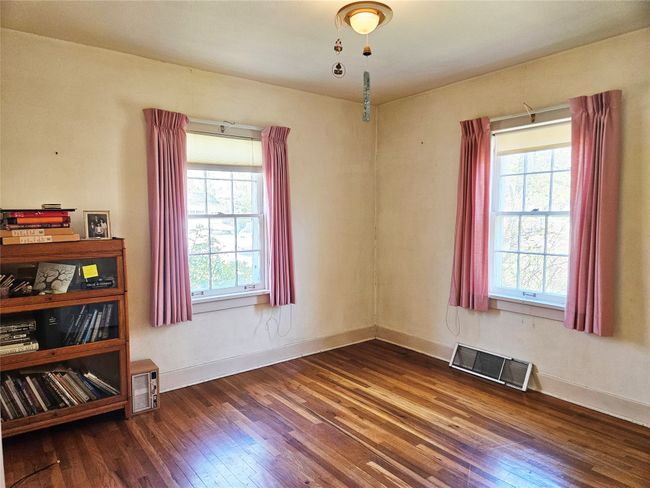 Empty room with visible vents, hardwood / wood-style floors, and a healthy amount of sunlight | Image 12