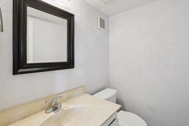 Half bathroom featuring vanity and a textured wall | Image 9