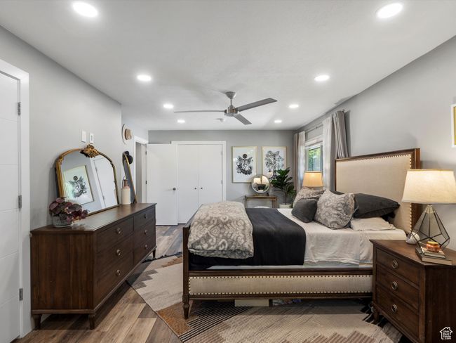 Bedroom featuring wood finished floors, recessed lighting, ceiling fan, and a closet | Image 24