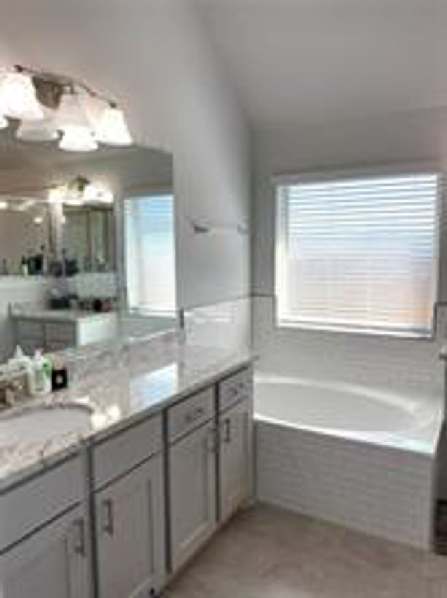 Bathroom with a bath and vanity | Image 10
