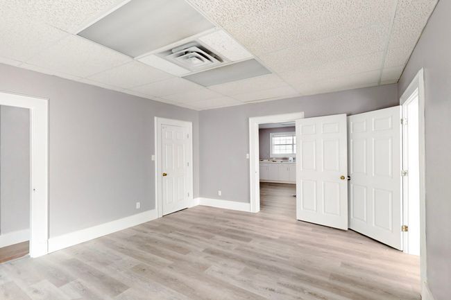 Unfurnished bedroom featuring a paneled ceiling and light hardwood / wood-style flooring | Image 15