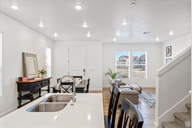 Kitchen with plenty of natural light, wood finished floors, recessed lighting, and light countertops | Image 10