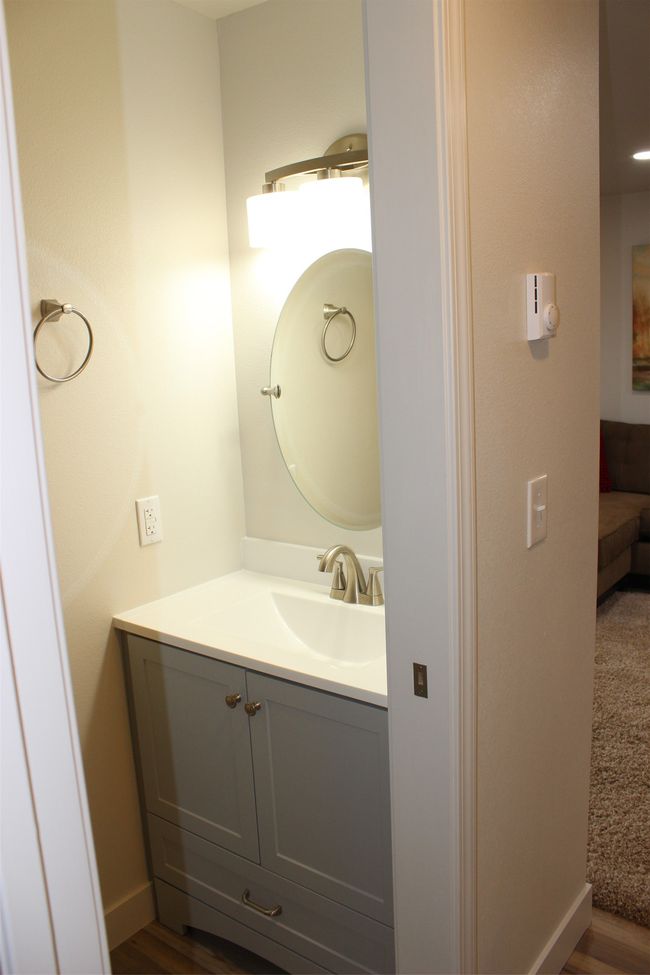 Bathroom with vanity and wood finished floors | Image 12