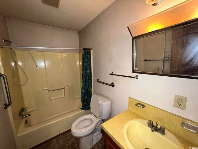Bathroom featuring vanity, shower / tub combo with curtain, and toilet | Image 20