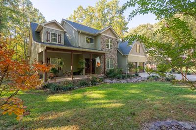 This custom home has a seasonal lake view. | Image 3