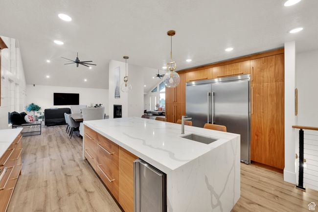 Kitchen with modern cabinets, built in refrigerator, ceiling fan, light wood-type flooring, and recessed lighting | Image 6