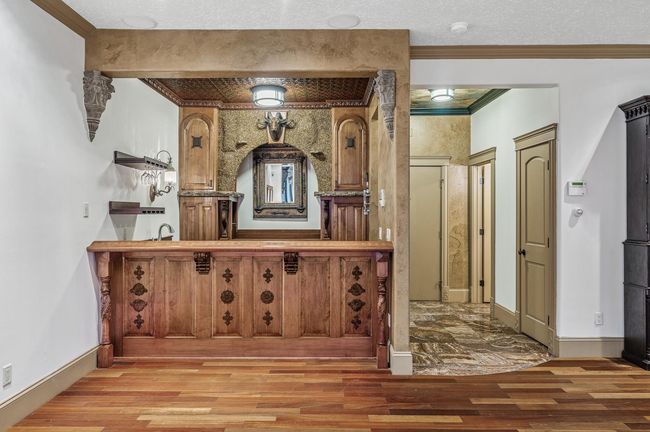 The bar is full of custom artwork including the mahogany bar with hand-carved accents..jpg | Image 4