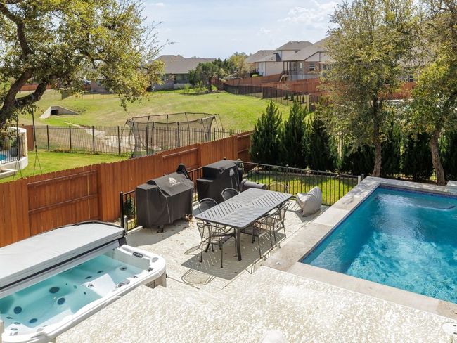 View of pool featuring a fenced backyard, a lawn, and a patio | Image 34