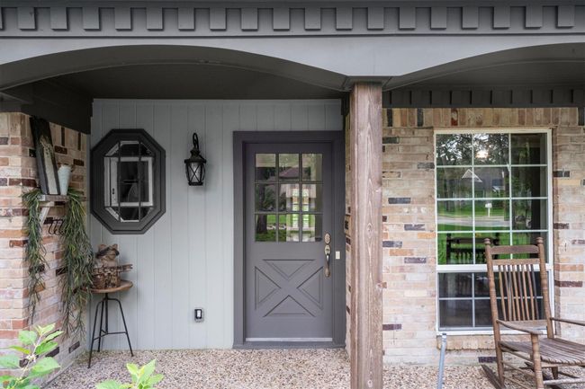 Charming front porch with a covered entryway adding protection from the elements while allowing you to enjoy the beautiful weather from the front yard. | Image 4