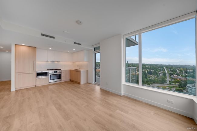 Kitchen with modern cabinets, oven, baseboards, light wood-type flooring, and recessed lighting | Image 5