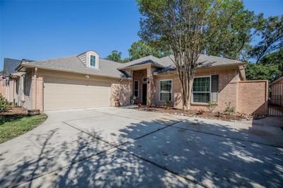 Beautiful single-story brick home featuring 3 bedrooms, 2.5 bath & two-car garage, a well-maintained driveway, and a mature tree in the front yard, providing shade and curb appeal. | Image 1