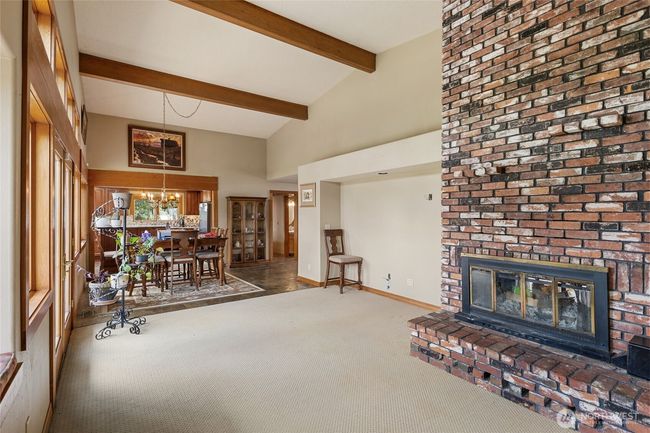 High vaulted ceilings with oak beams complement this great room. Enjoy this vintage 2 sided brick fireplace. | Image 12