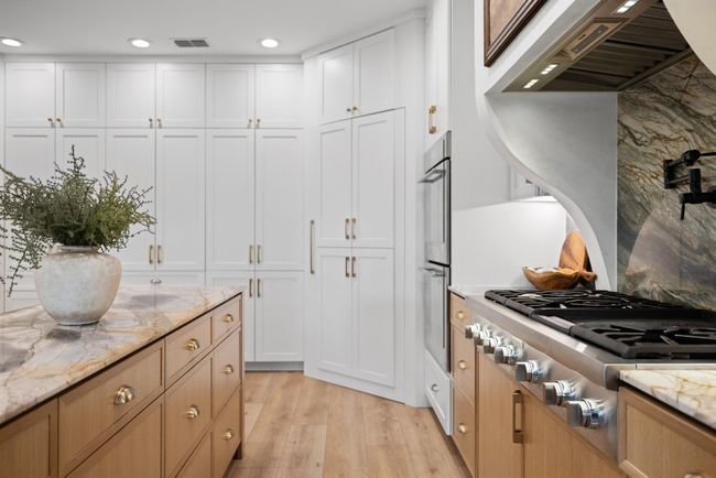 Kitchen with visible vents, premium range hood, light wood-style floors, stainless steel appliances, and recessed lighting | Image 22