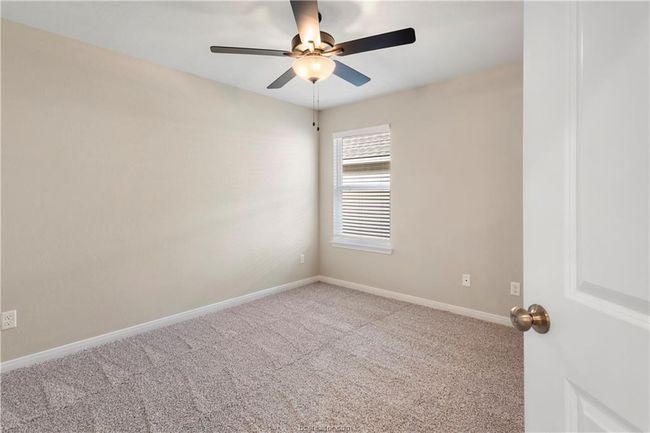 Carpeted room featuring ceiling fan and baseboards | Image 18