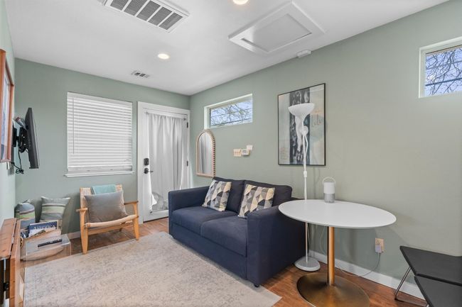 Living area featuring visible vents, a healthy amount of sunlight, attic access, and wood finished floors | Image 28