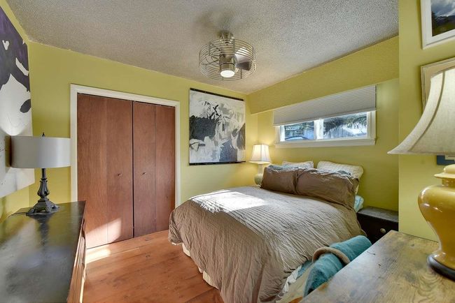 Bedroom with a closet, wood finished floors, and a textured ceiling | Image 27