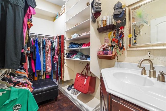 One of the walk in closets in the primary suite. Yes there is an additional sink in the closet! | Image 28