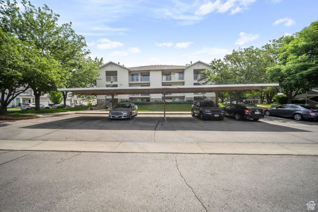 View of property featuring covered and uncovered parking | Image 14
