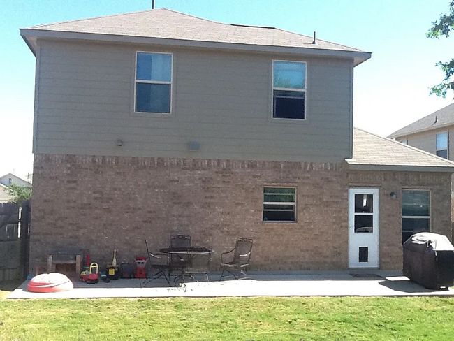 Back of property with a yard, brick siding, a patio area, and a shingled roof | Image 10