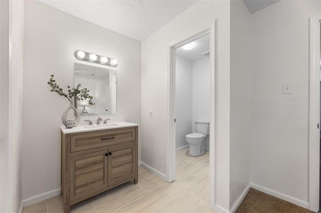 Modern vanity with sleek, updated bathroom design. | Image 17