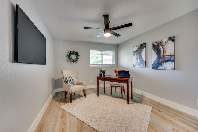 Office area with light wood-type flooring and ceiling fan | Image 26