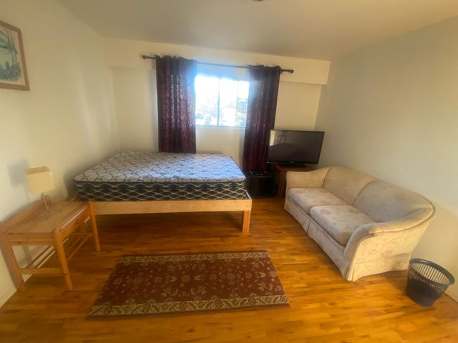 Bedroom with wood finished floors | Image 5