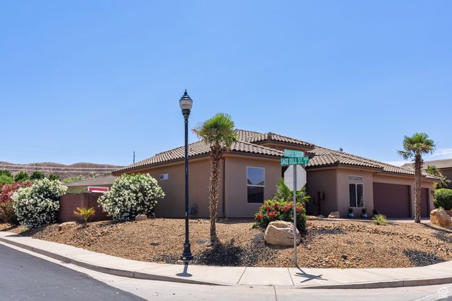 View of front of house with an attached garage, stucco siding, and a tiled roof | Image 49